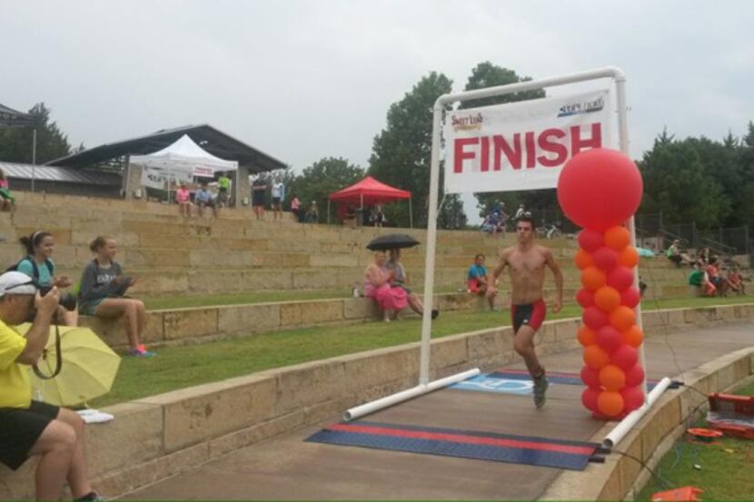 Jeremy Cerf crosses the finish line after swimmings 300 meteres, biking 15 miles and running...