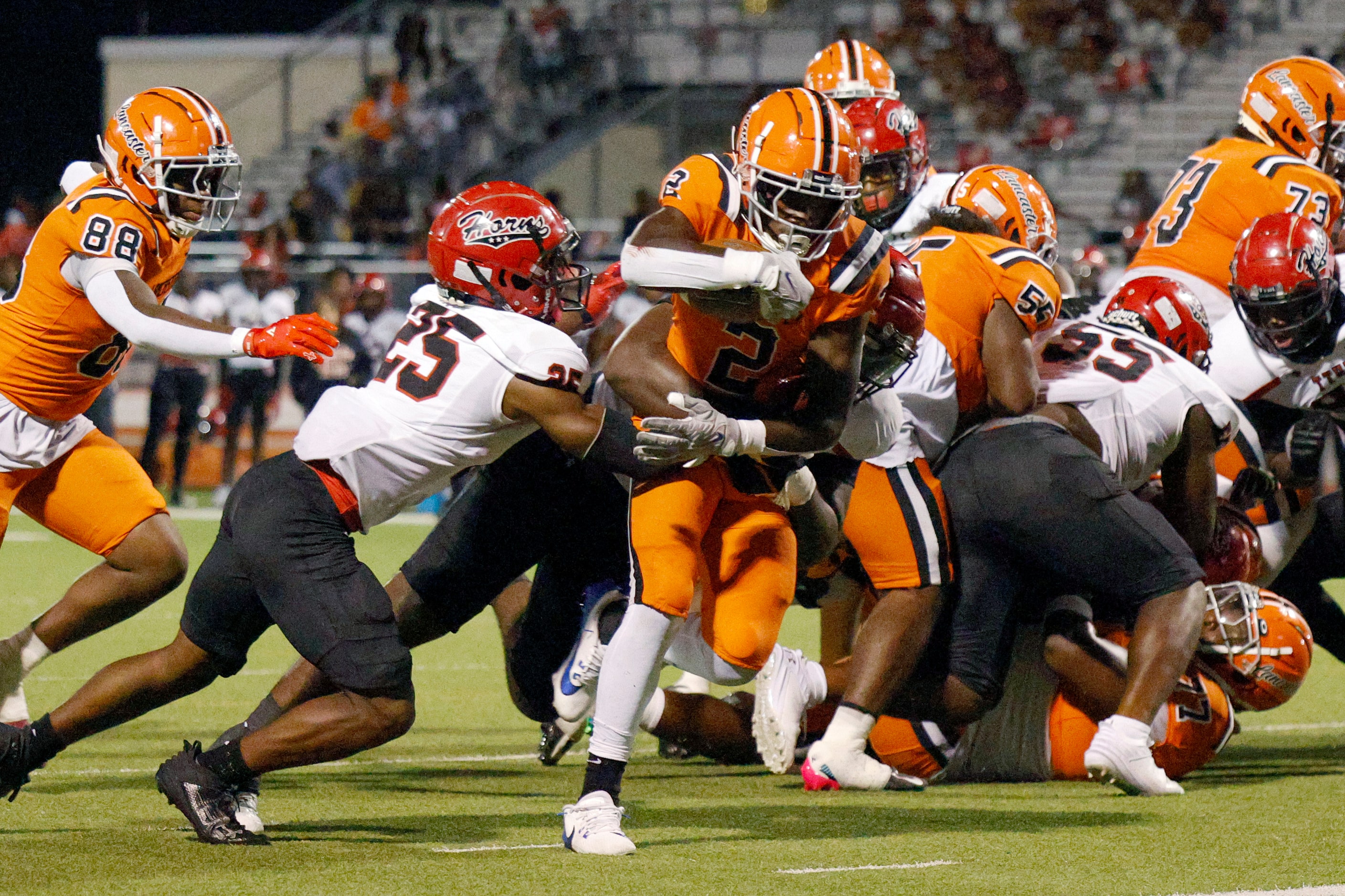 Lancaster running back Izayah Lee (2) powers through the arms of Lancaster defensive back...