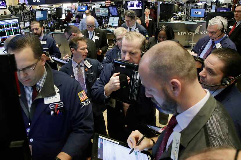 In a Thursday, Feb. 9, 2017 file photo, stock traders follow market activity, at the New...