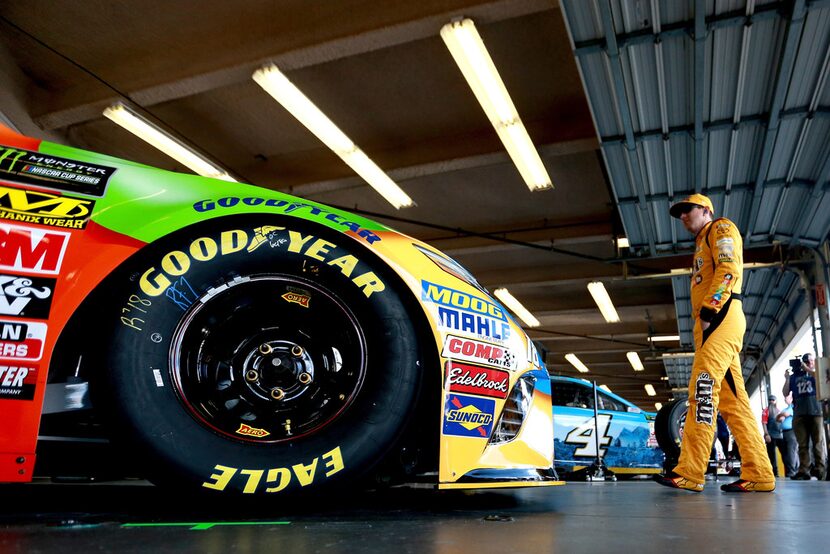 DAYTONA BEACH, FL - FEBRUARY 10:  Kyle Busch, driver of the #18 M&M's Toyota, stands in the...