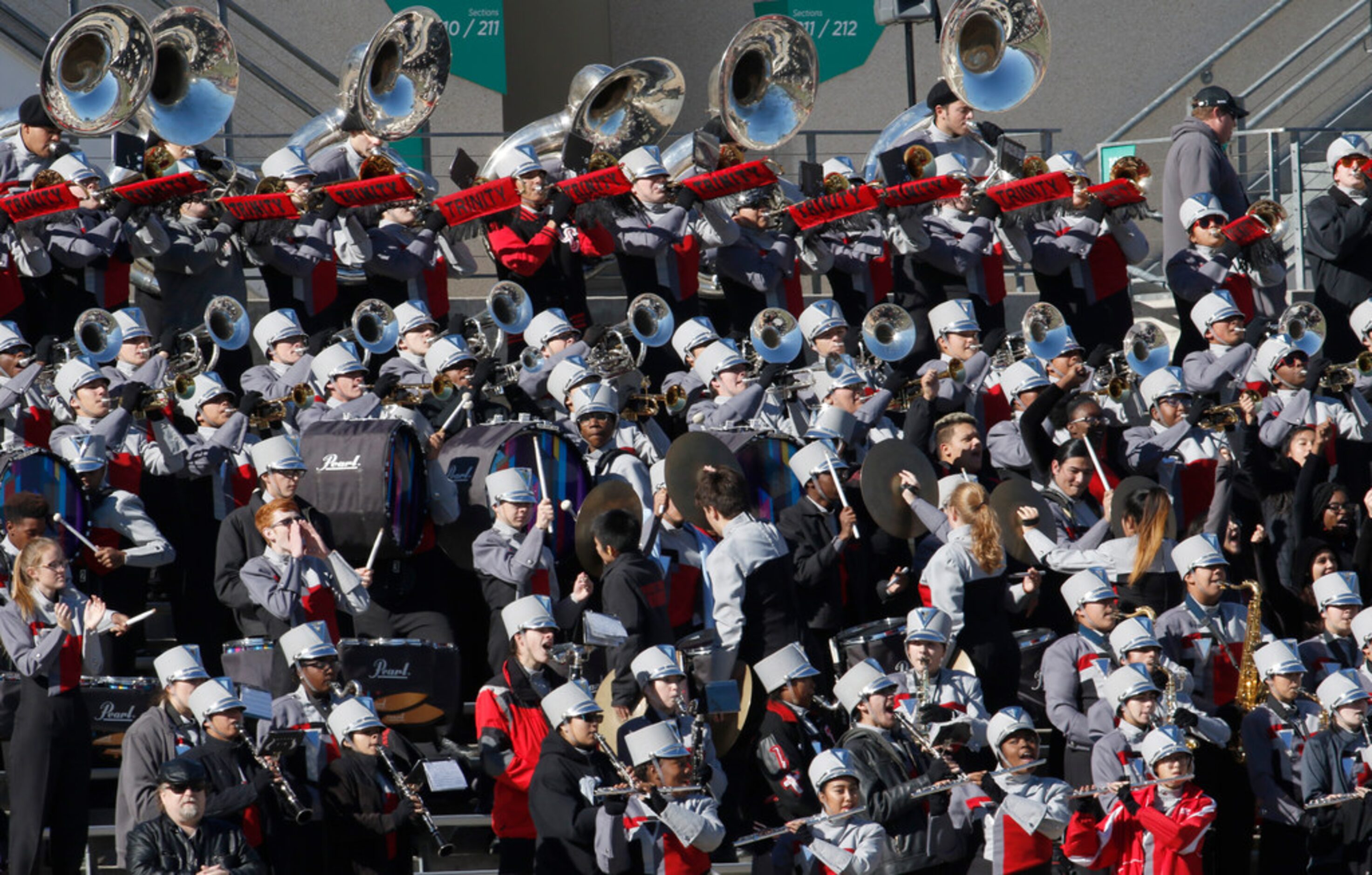 Members of the Euless Trinity band perform from the stands during the first quarter of play...