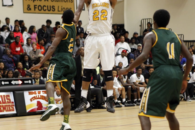 Triple A Academy guard King McClure (22) shoots over Madison guard Cameron Bryant (2) as...