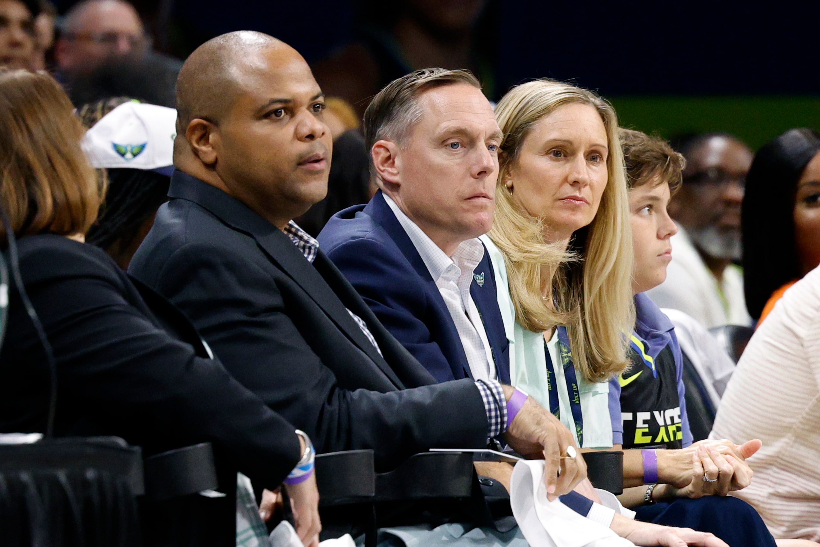 Dallas Mayor Eric Johnson (left) and Dallas Wings president and CEO Greg Bibb (center) watch...