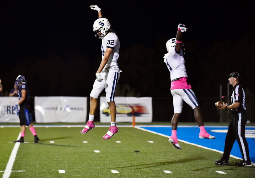 Fort Worth All Saints senior wide receivers Brendan Harmon (32), left, and Jaylon Robinson...