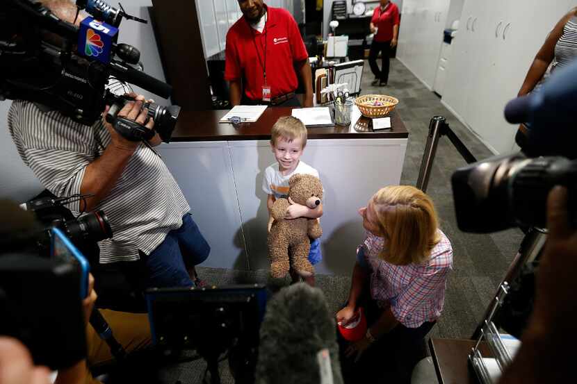 Luke Swofford, 4, and his mother Nikki Swofford talk with the media inside the Lost and...