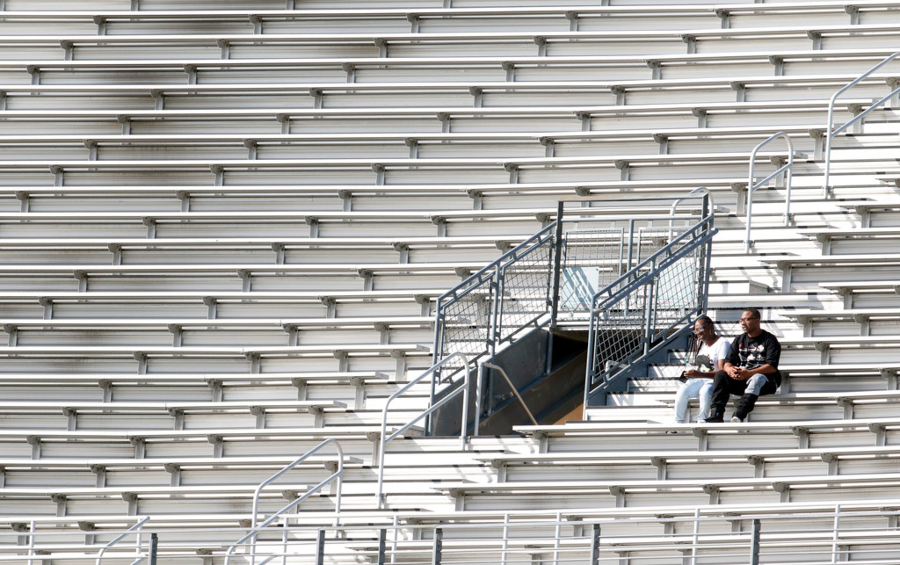 A couple of fans chose seats in the upper deck that offered plenty of elbow room as they...