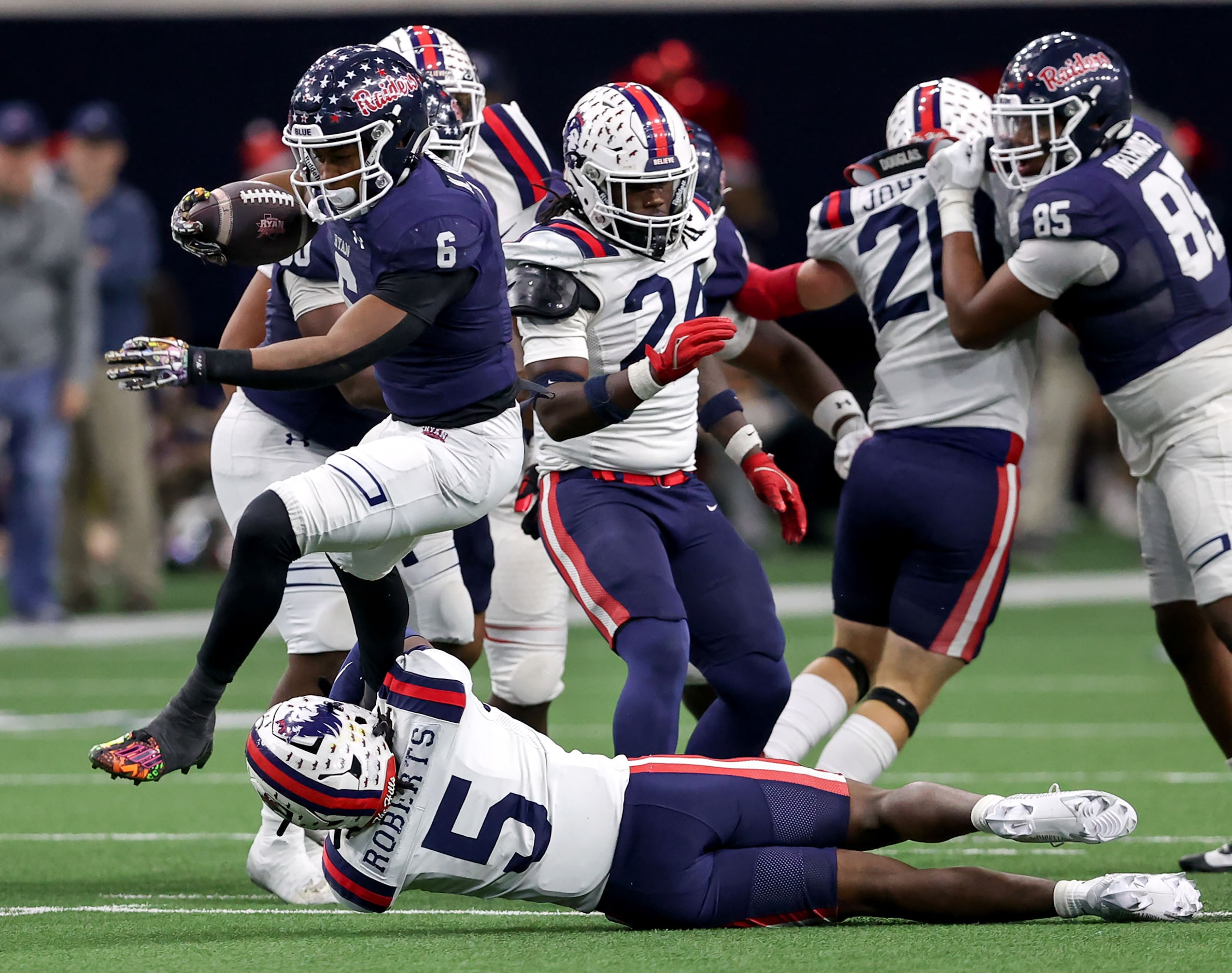 Denton Ryan running back Nemo Warmate (6) tries to leap over Richland linebacker Roddrick...