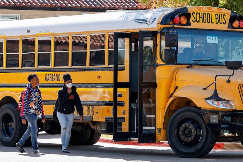 Students boarded a Garland ISD bus outside Garland High School on Oct. 22, 2021.