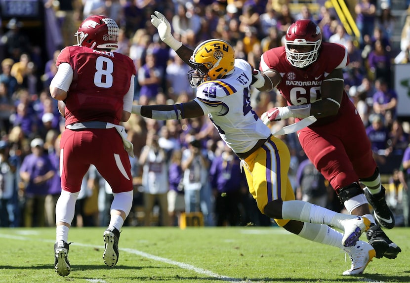 FILE - In this Nov. 11, 2017, file photo, Arkansas quarterback Austin Allen (8) scrambles...