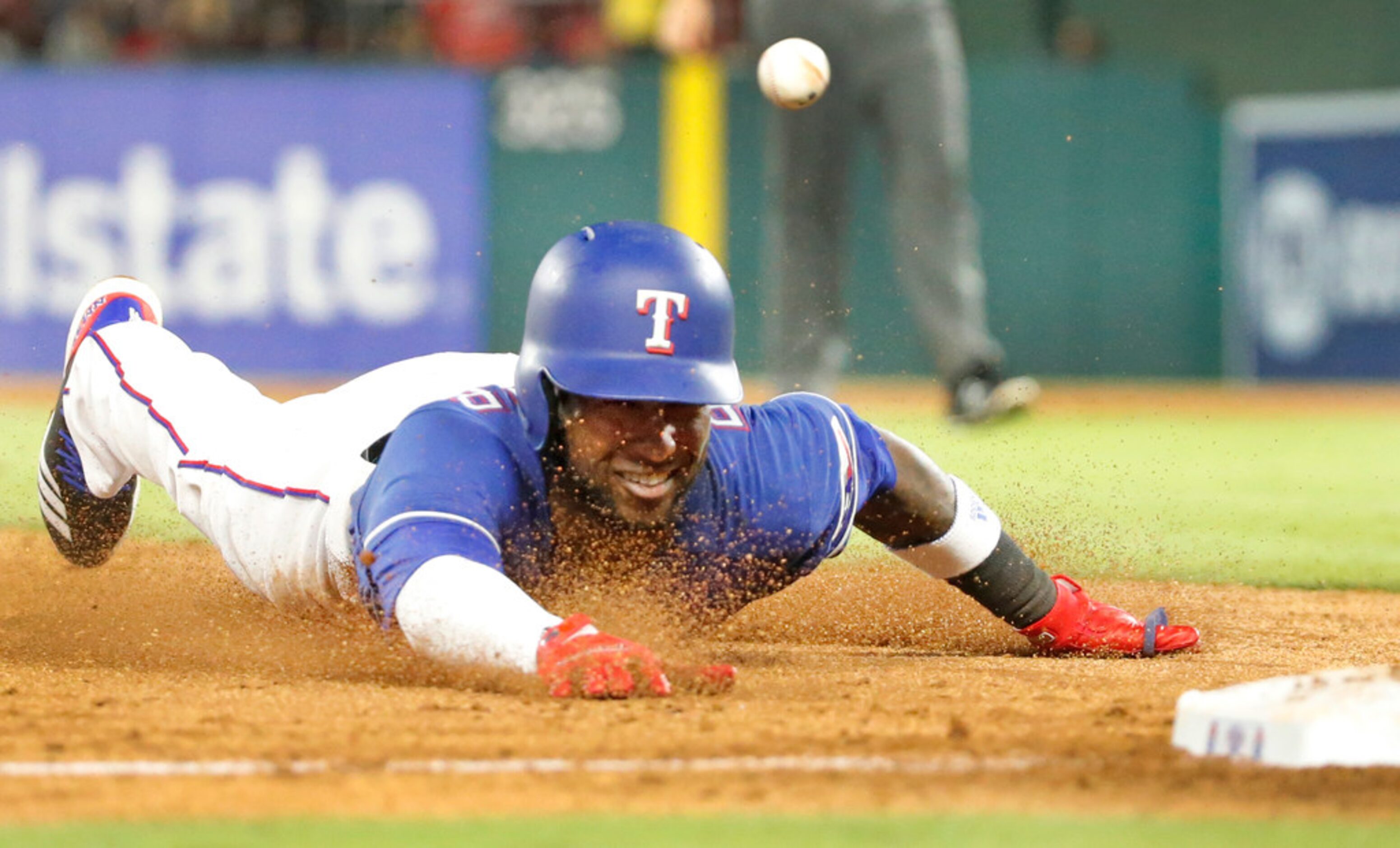 Texas Rangers shortstop Jurickson Profar (19) advances to third on a fly ball out in the...