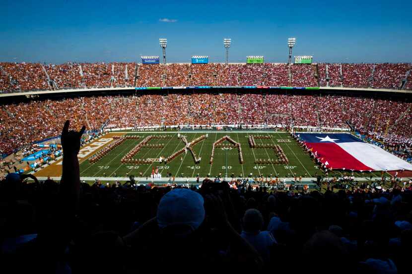 Texas Longhorns fans cheer as the band performs before the AT&T Red River Showdown college...