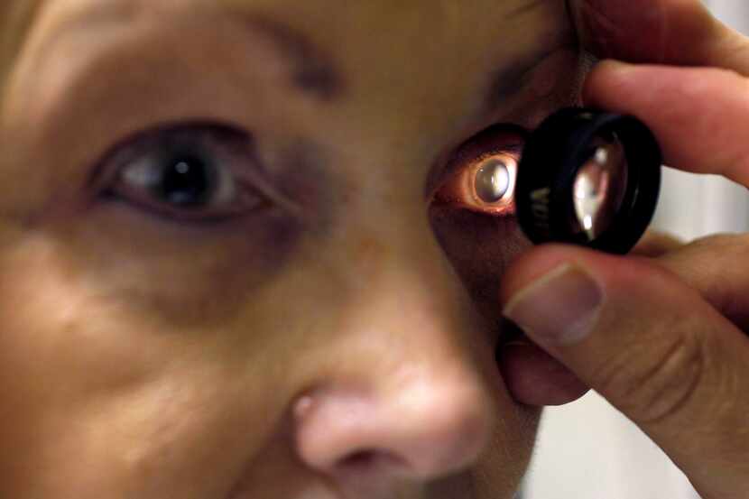 Jennifer Tyler gets an eye exam to look for changes in her macular degeneration at Texas...