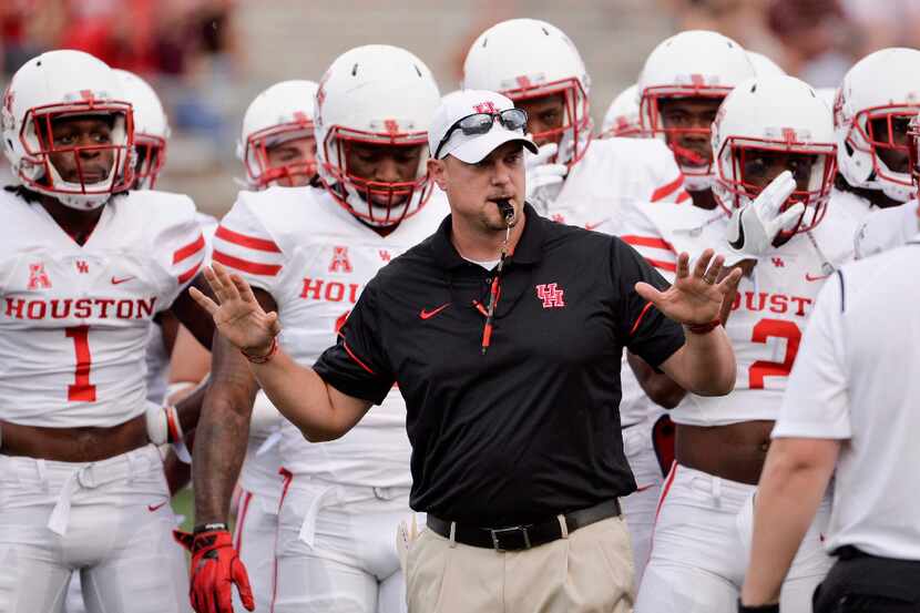 Houston head coach Tom Herman runs drills with his team before an NCAA college football game...