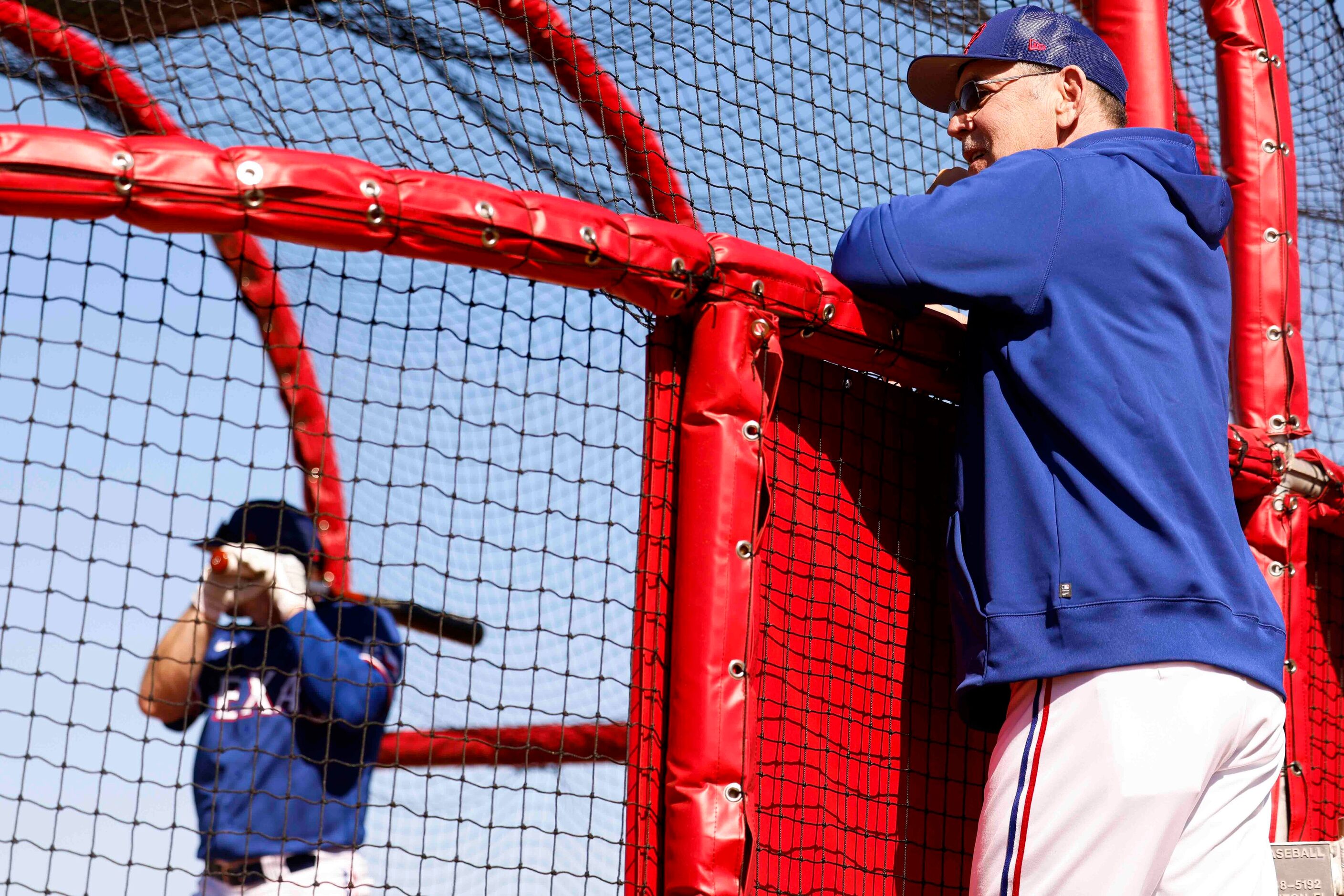 Texas Rangers manager Bruce Bochy observes batting practice during a spring training workout...