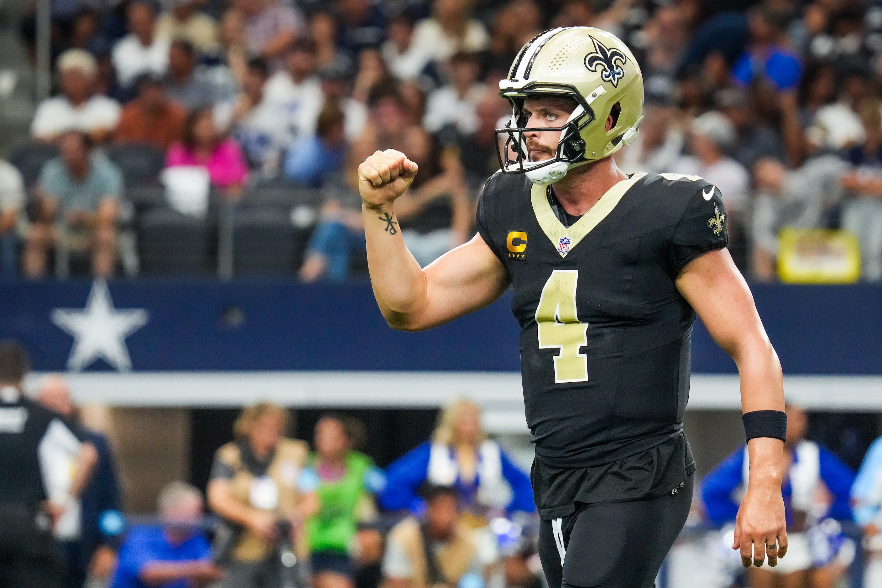 New Orleans Saints quarterback Derek Carr celebrates a touchdown run by running back Alvin...