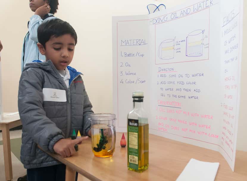 Shaunak Jadhav,5, demonstrates her science project on mixing oil and water during the...