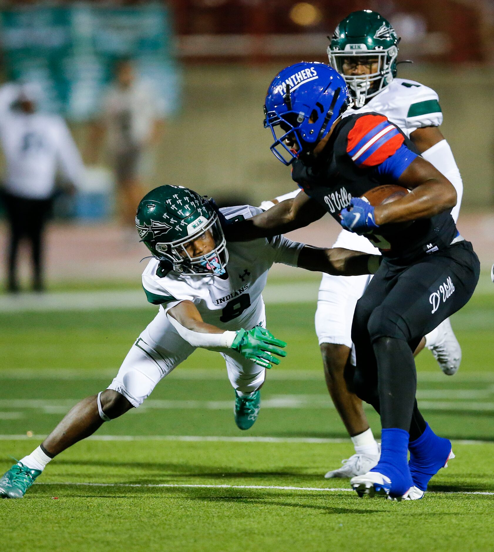 Duncanville senior running back Malachi Medlock (5) stiff arms Waxahachie junior defensive...