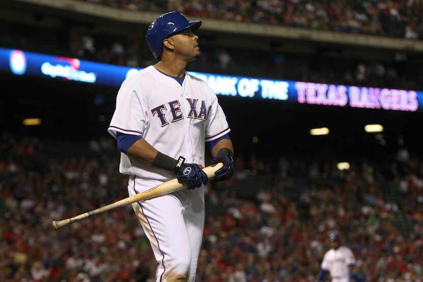 Texas Rangers right fielder Nelson Cruz (17) walks off after striking out against the...