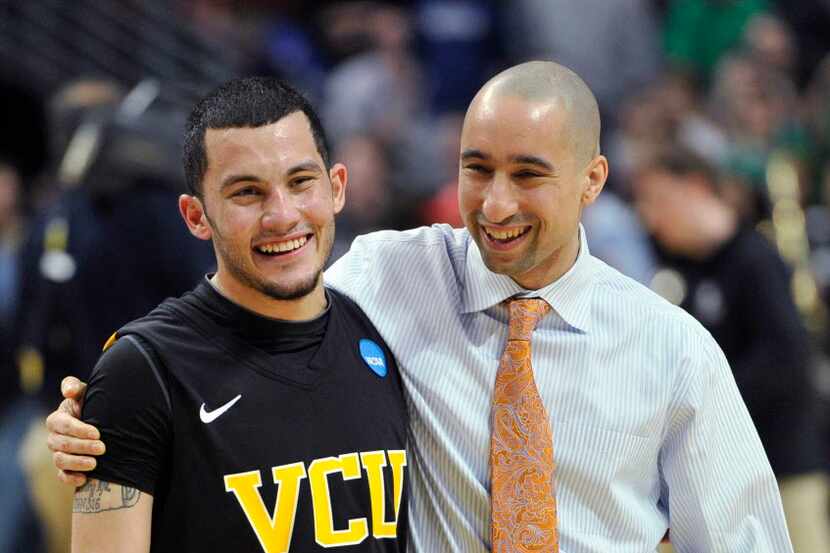Virginia Commonwealth guard Joey Rodriguez (12) and coach Shaka Smart smile after a...