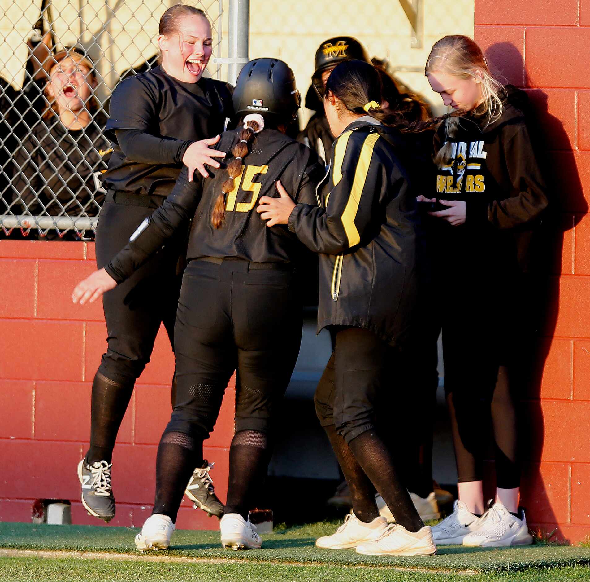 Memorial first baseman Peyton Chianese (27) congratulates third baseman Payton Newlin (15)...