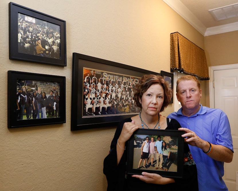 Lisa and Dave Stephenson hold a photograph of them with Thomas Johnson and Maria Paula in...