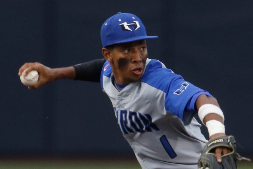 Hebron shortstop Diego Johnson (1) throws out a Keller batter after fielding a sharply hit...