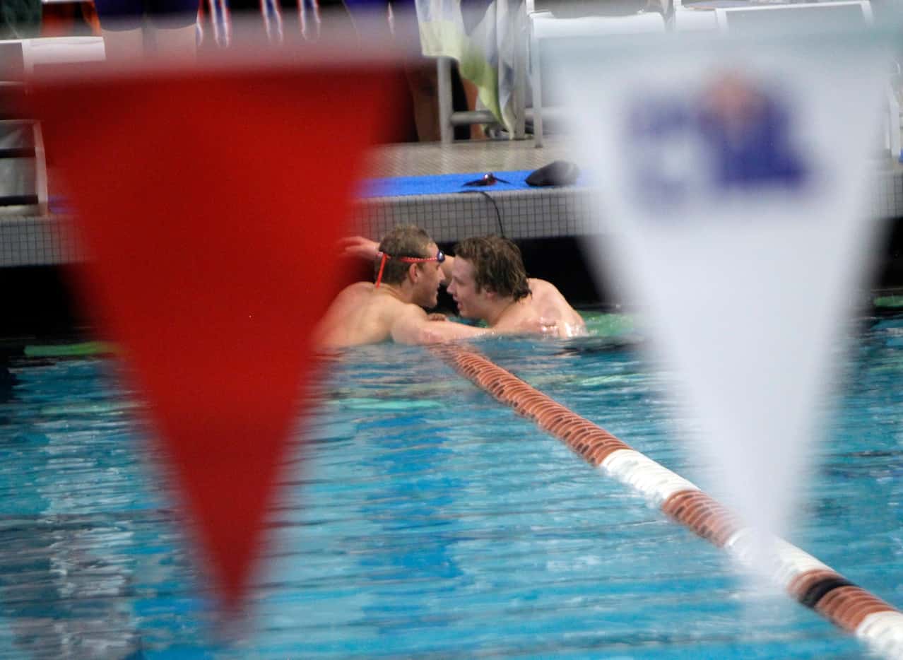 Southlake Carroll freshman swimmer Maximus Williamson, left, receives a congratulatory hug...