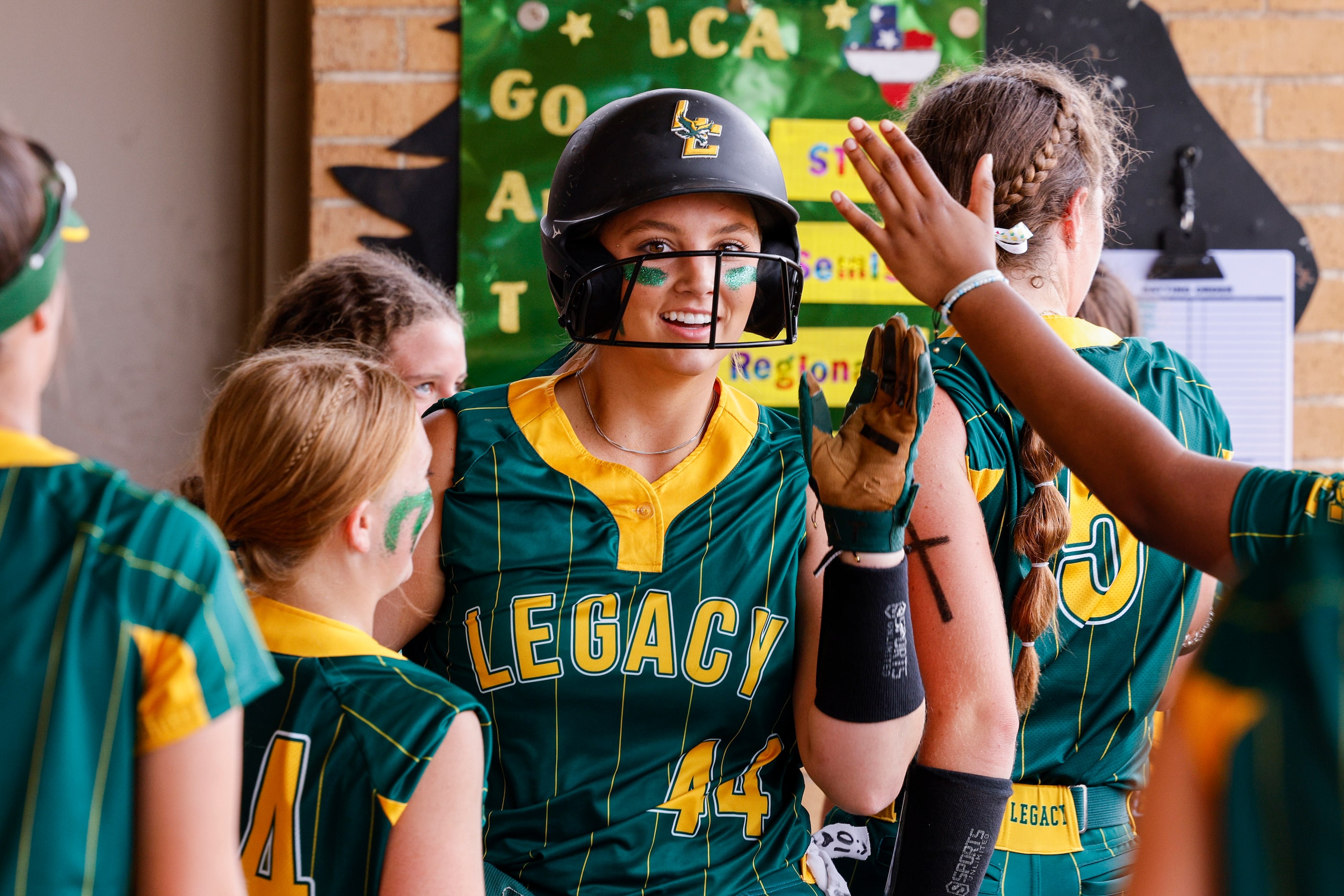 Frisco Legacy Christian pitcher Ronnie Johnson (44) celebrates with teammates in the dugout...