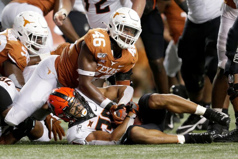 Chuba Hubbard #30 of the Oklahoma State Cowboys is stopped short on a fourth down by Joseph...