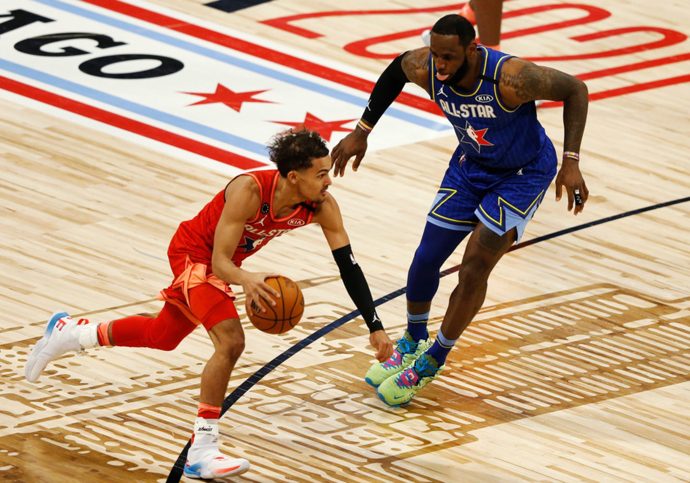 Team Giannis' Trae Young (24) drives on Team LeBron's LeBron James (2) during the second...