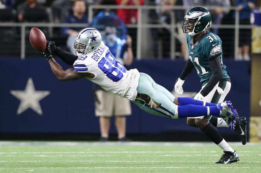 Dallas Cowboys wide receiver Dez Bryant (88) dives for the ball but misses as he is defended...