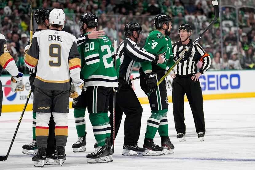 Dallas Stars left wing Jamie Benn, right, is escorted by officials as Vegas Golden Knights'...