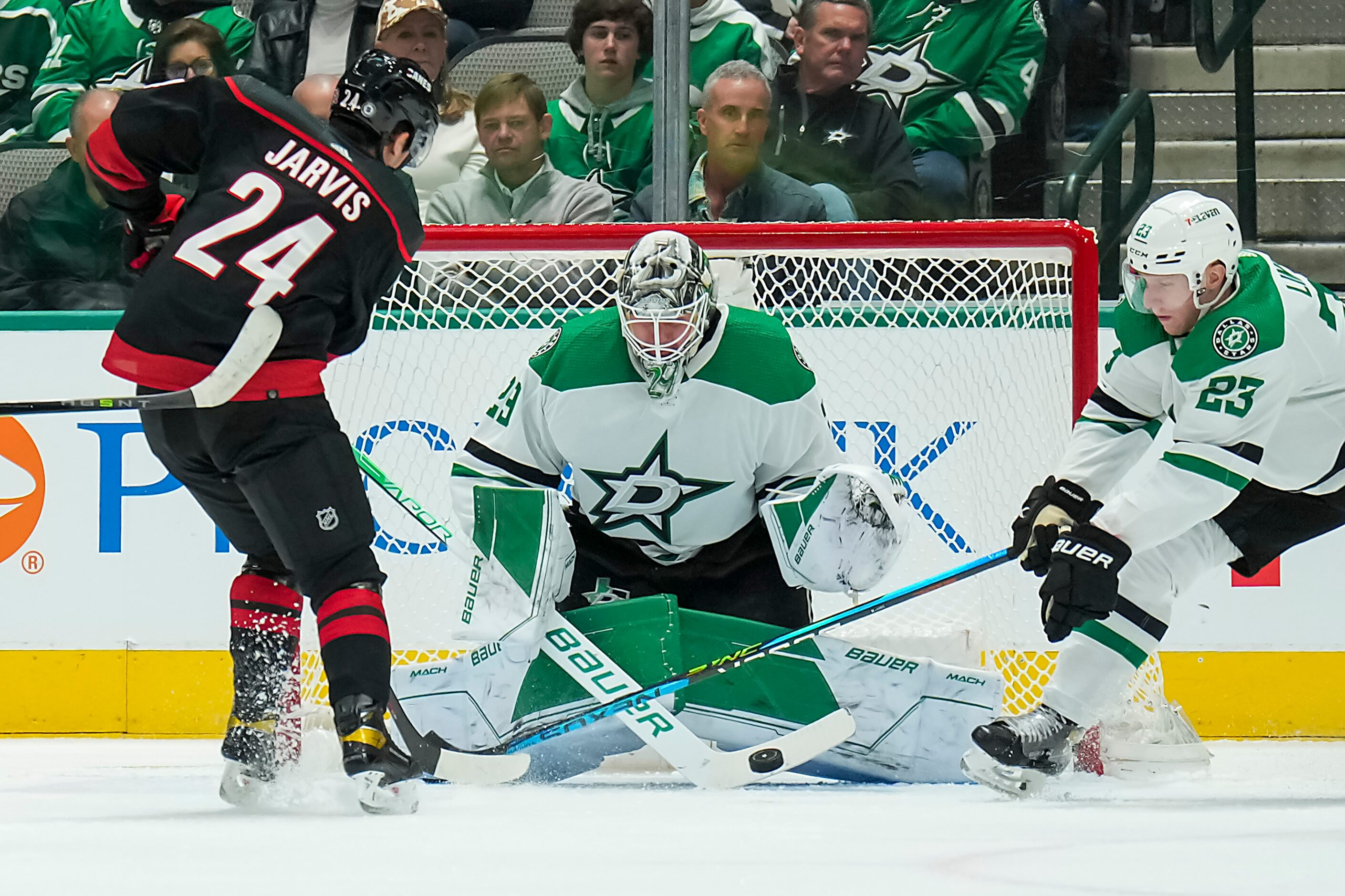 Dallas Stars goaltender Jake Oettinger (29) turns away Carolina Hurricanes center Seth...