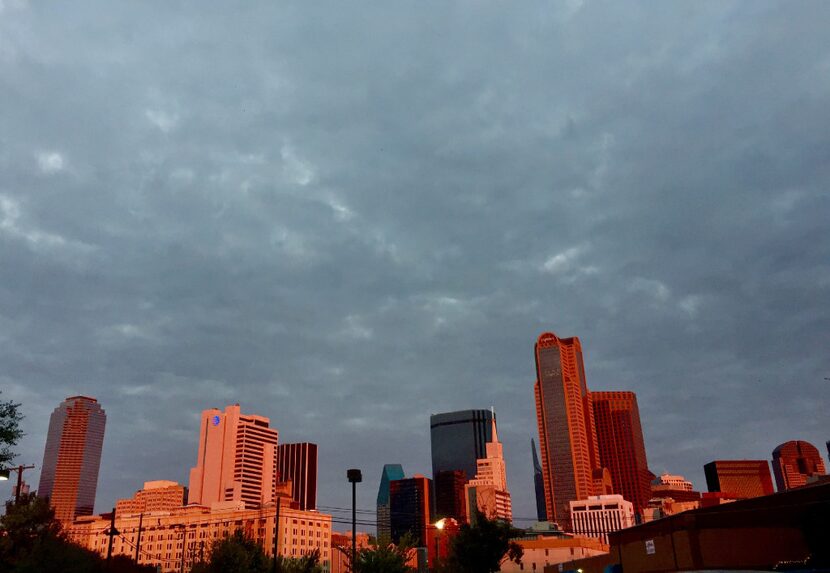 The view from 1818 Corsicana Street shows the downtown Dallas skyline reflecting an early...