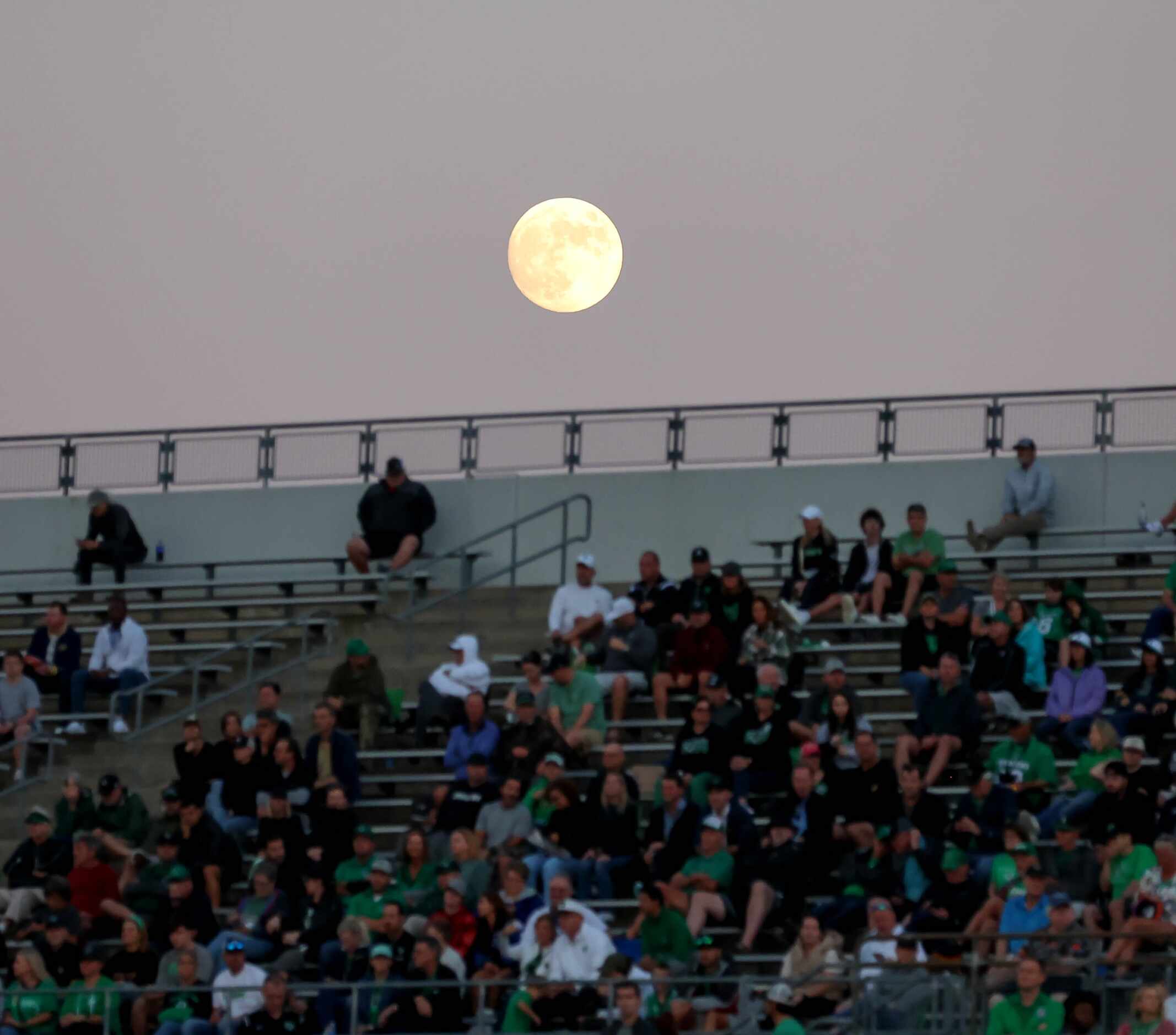 The moon lies over the stands during the game against Byron Nelson and Southlake Carroll in...