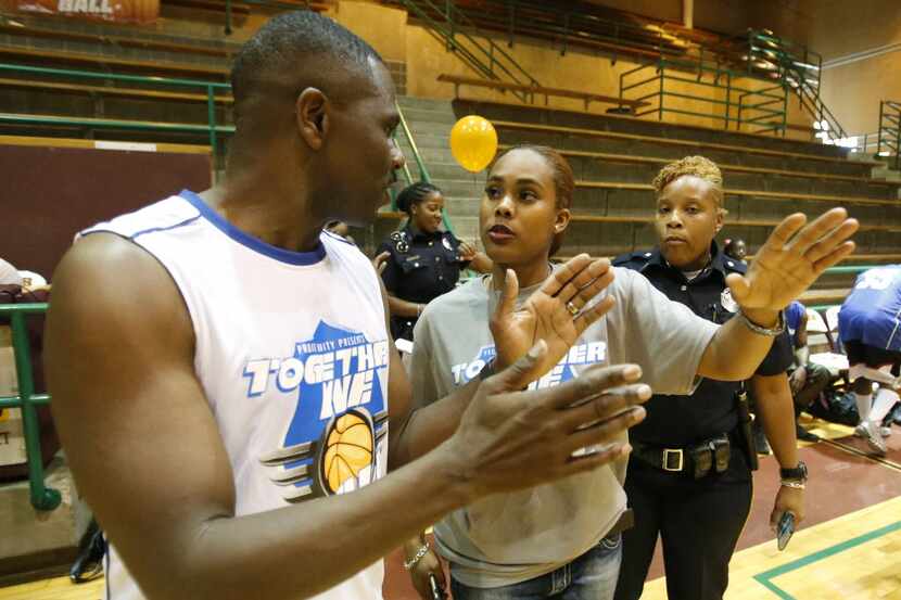 Pastor Richie Butler of St. Paul United Methodist Church talks with basketball coach, Dallas...