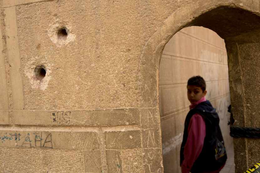Bullets holes are visible on the police booth outside Mar Mina church in Helwan, Cairo,...