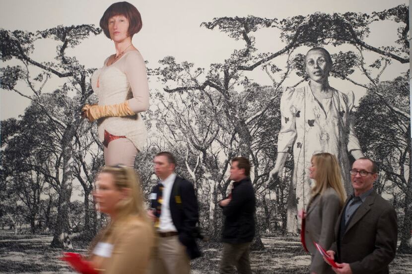 Guests walk past self portraits of Cindy Sherman during a press preview of Sherman's new...