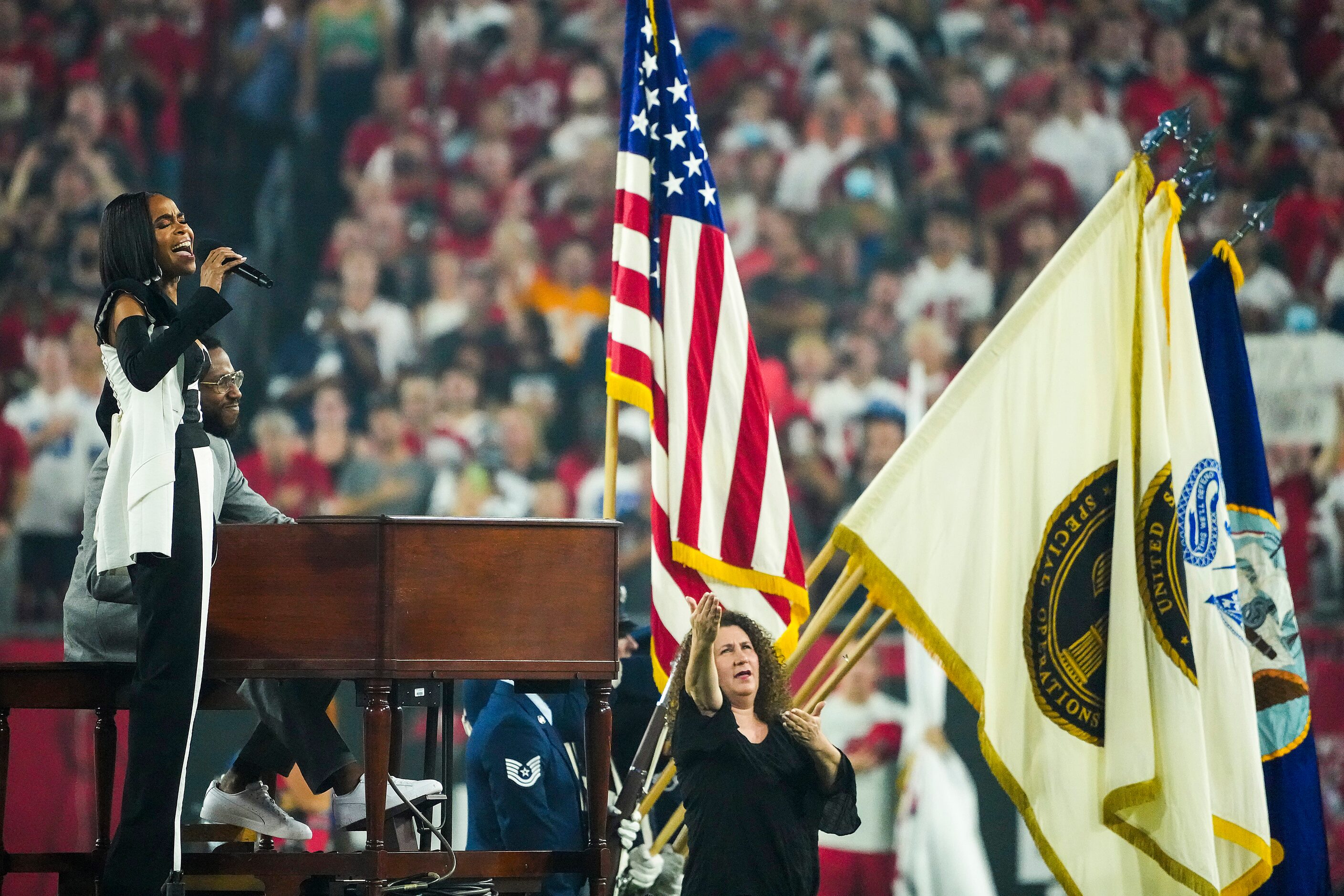 Michelle Williams sings the national anthem before an NFL football game between the Dallas...