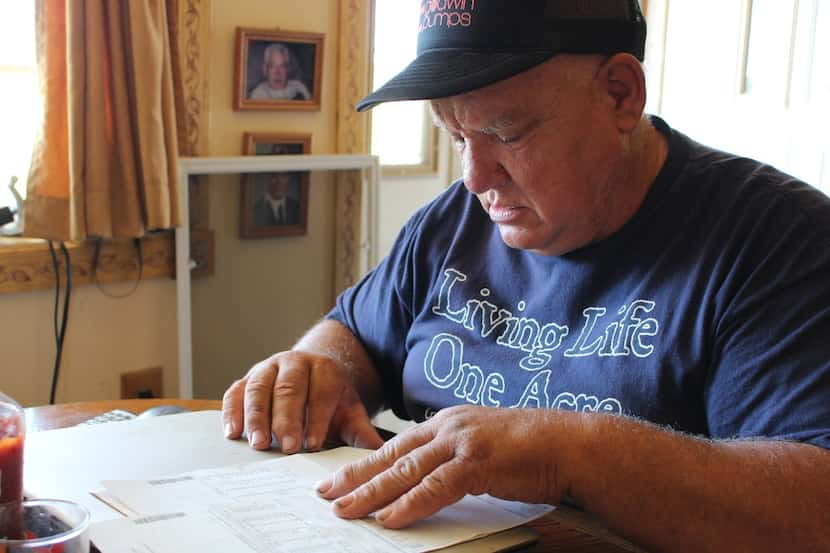 Jan Brown looks over a royalty statement at his home in Wyalusing, Pa. Brown and other...