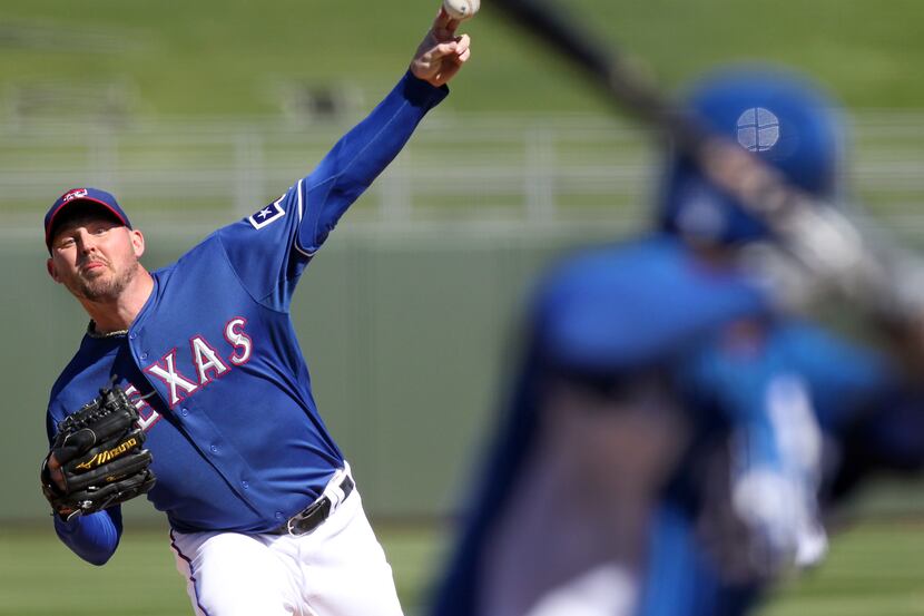 Texas Rangers starting pitcher Matt Harrison throws a first-inning pitch during the Texas...