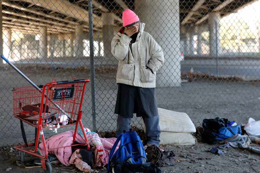 Tracy Larue, 48, stands next to the personal belongings of an elderly homeless man she said...