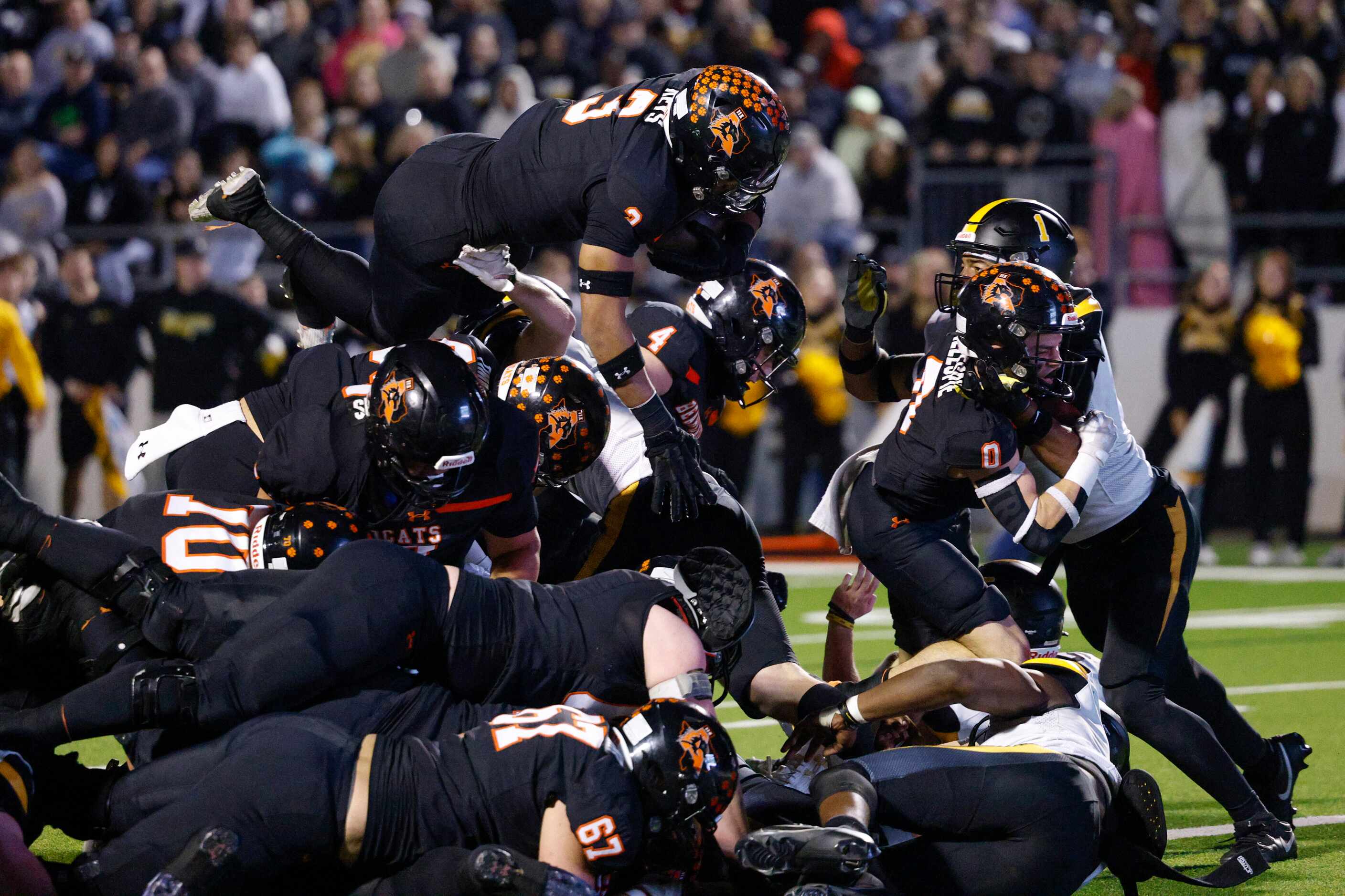 Aledo linebacker Davhon Keys (3) leaps over the line of scrimmage to score a touchdown...