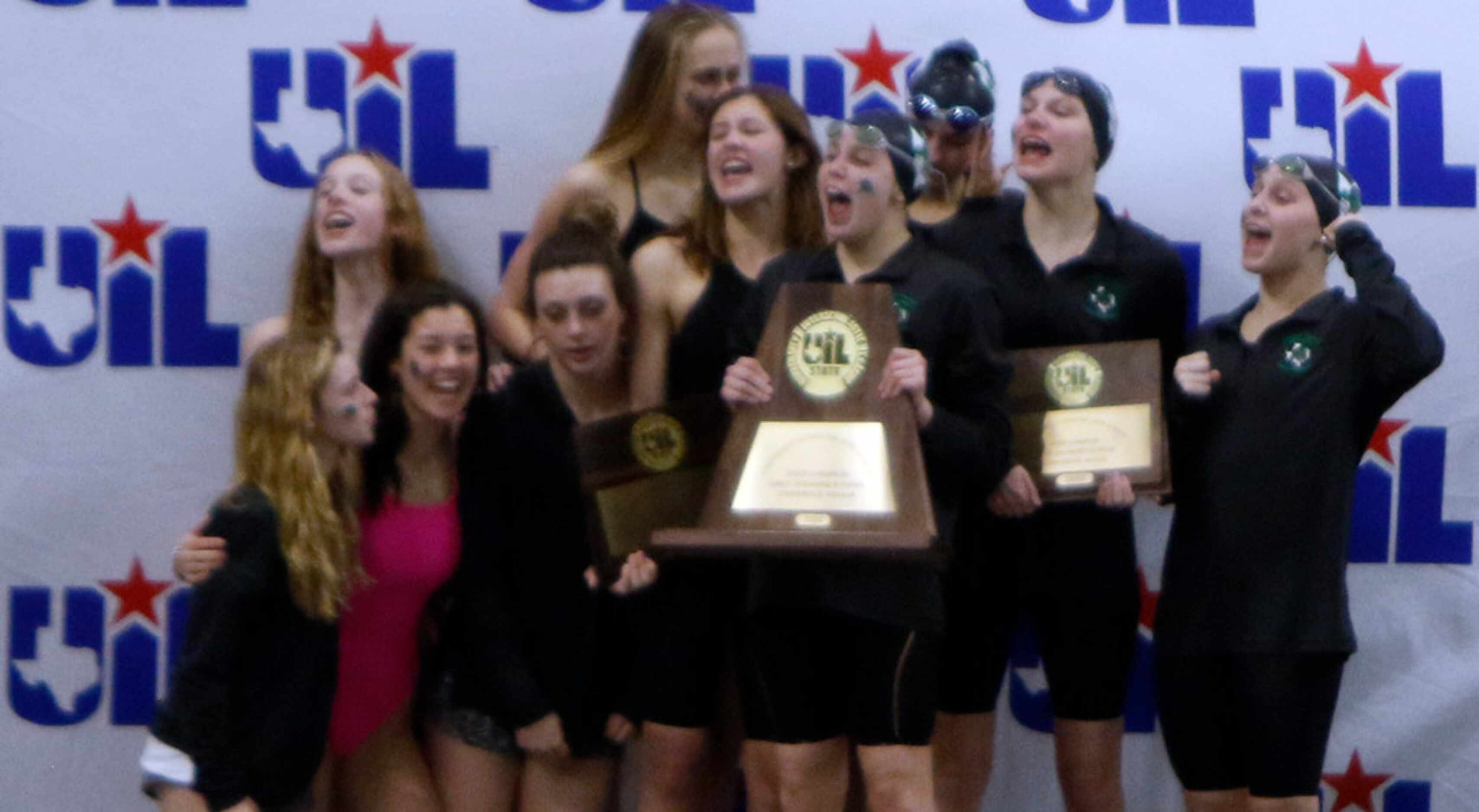 Members of the Southlake carroll girls swim team celebrate their first place victory win a...