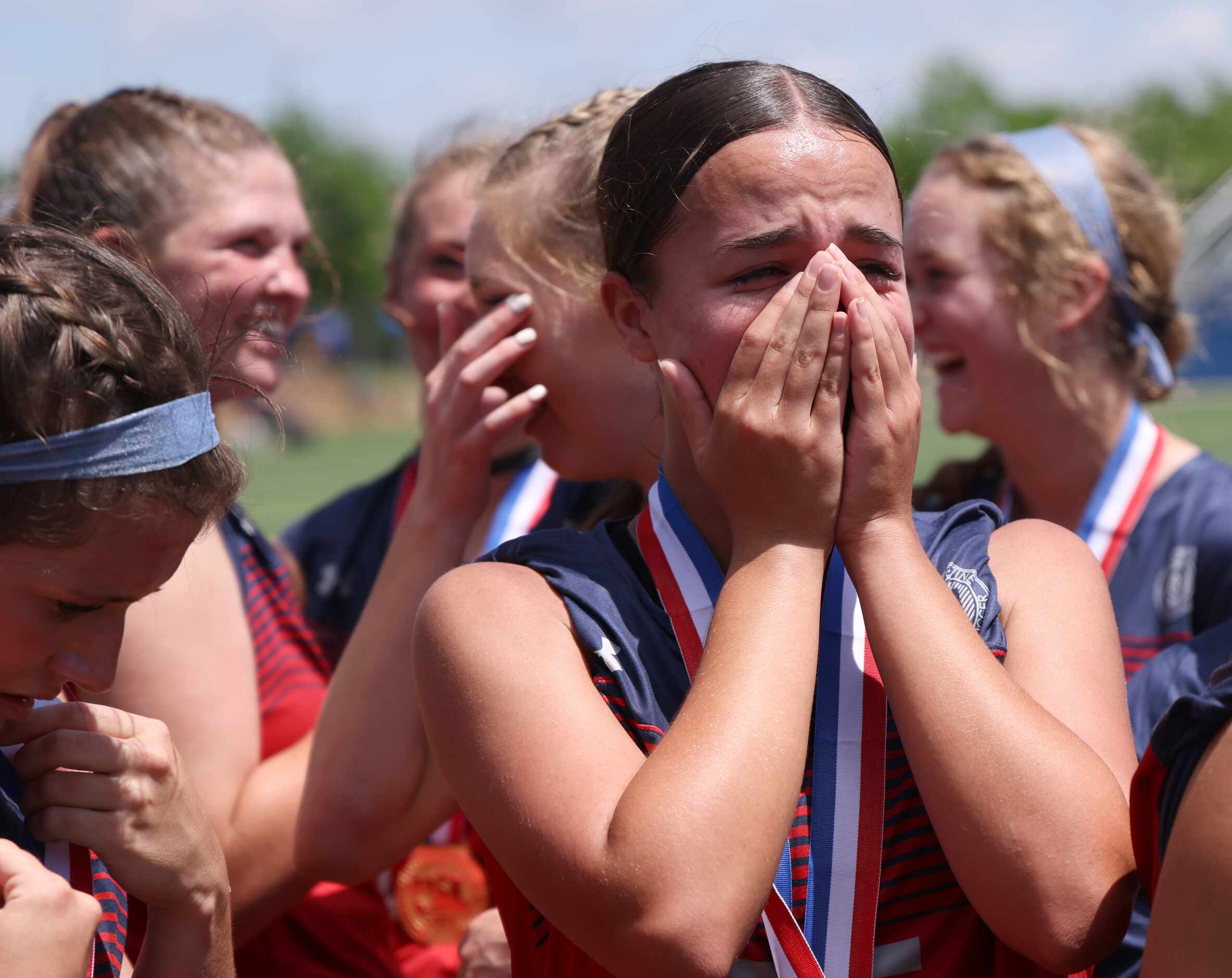 Grapevine defender Jenna Leverette (25) is overcome by the moment after team members...