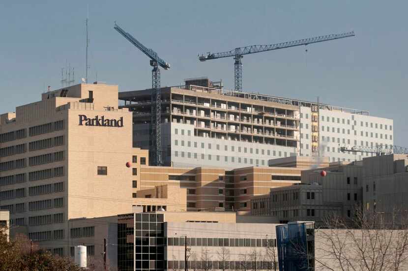 The old Parkland Hospital (foreground) is undergoing federal inspection as the new Parkland...