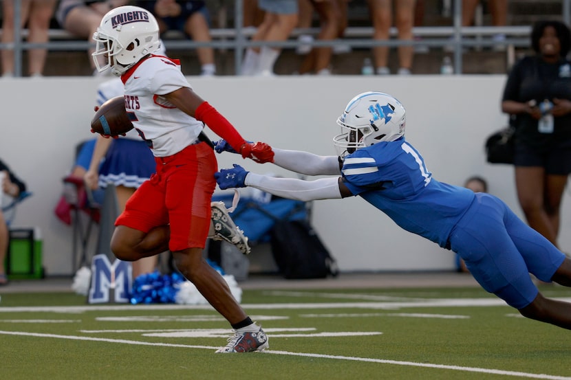 Kimball's Camrin Jackson (5) runs into the end zone for a touchdown as Midlothian's Daniel...