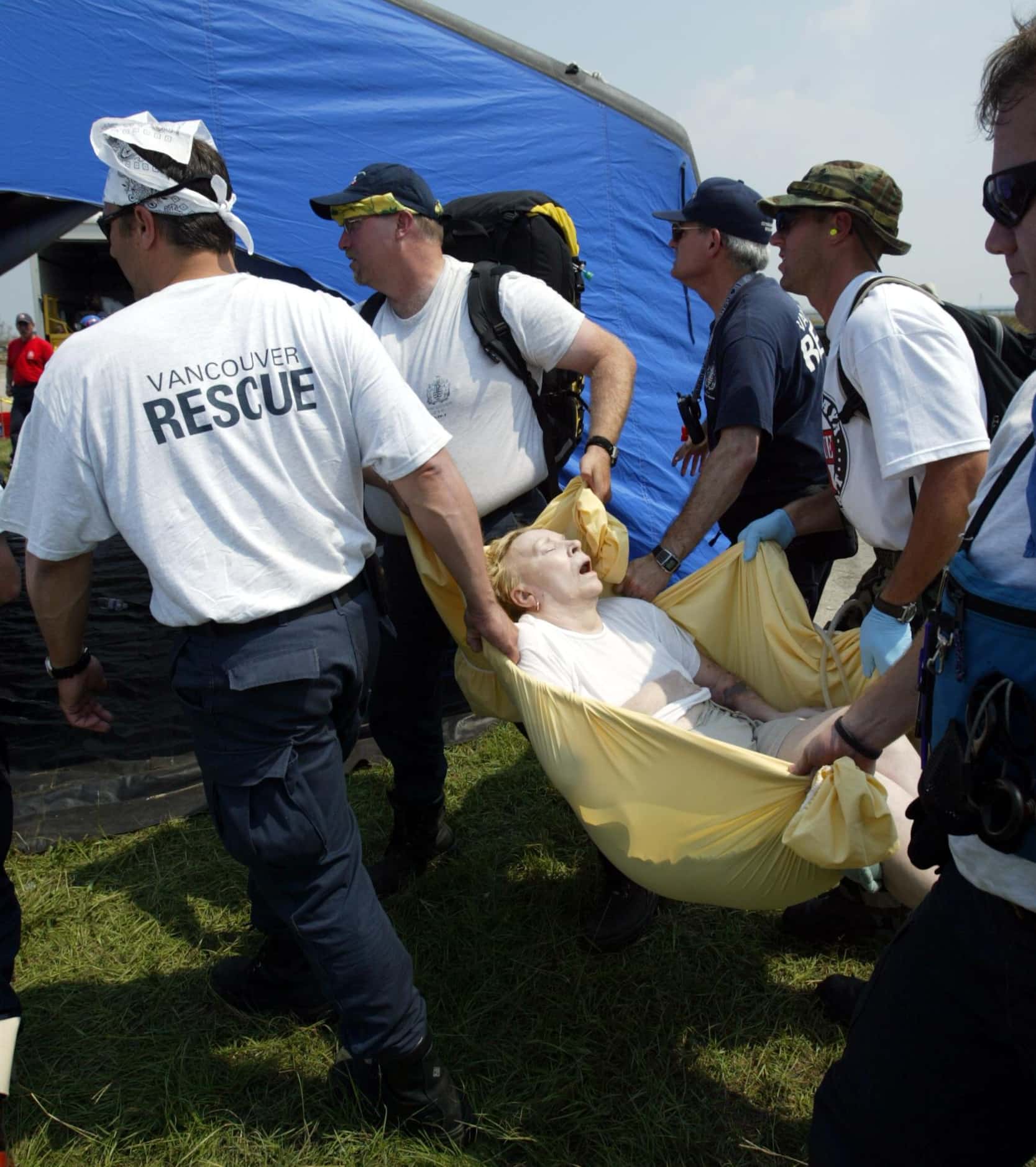 Fire and rescue team members from Vancouver, Canada, carried an elderly woman to a medical...