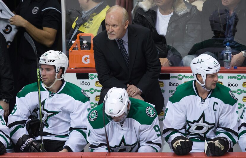 Dallas Stars coach Lindy Ruff, top, watches from the bench as Travis Morin, Tyler Seguin and...