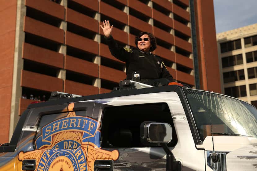 Dallas County Sheriff Lupe Valdez waved to the crowd during the Dallas Holiday Parade...